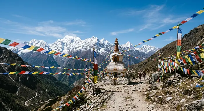 Prayer flags and a white chorten on a high mountain pass